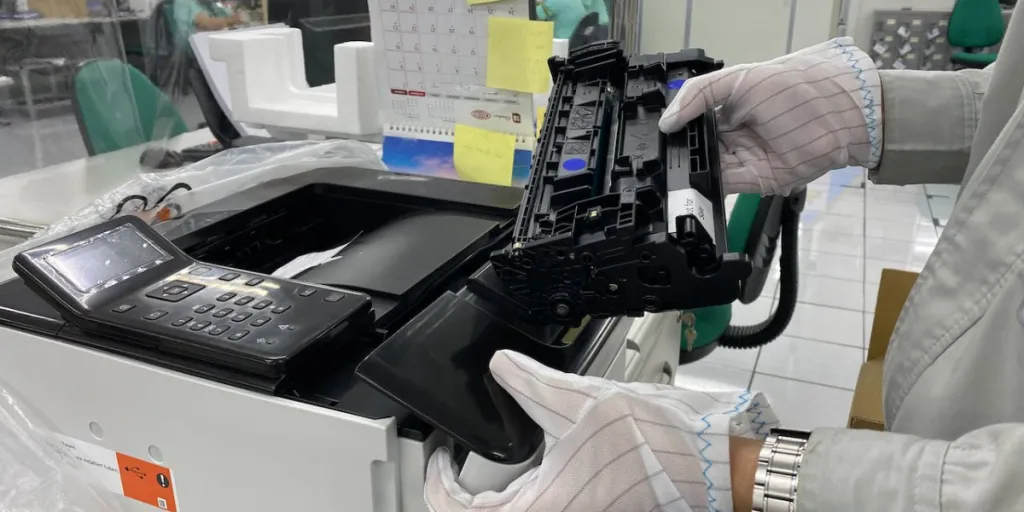 Man changing cartridge in a printer