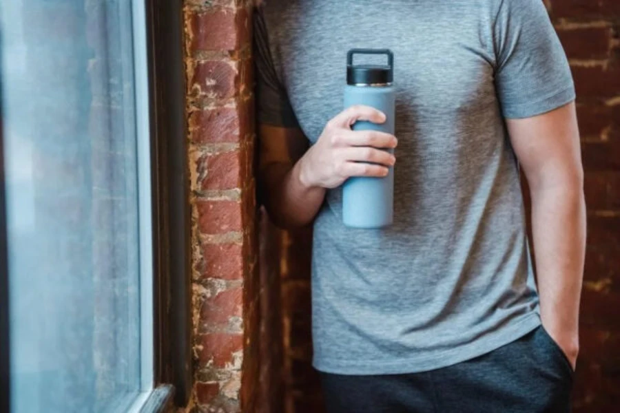 Man holding a sports gym water bottle