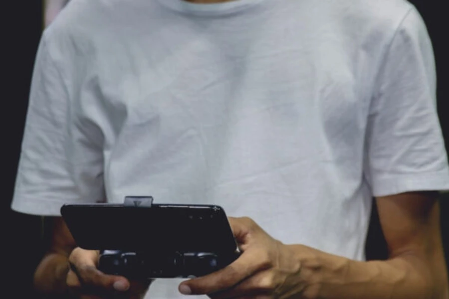 Man using a smartphone game controller