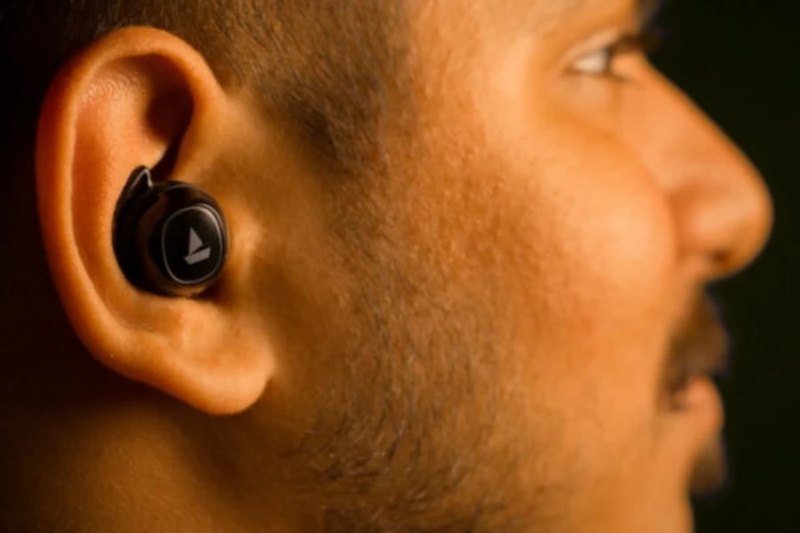 Man with wireless earbud in right ear