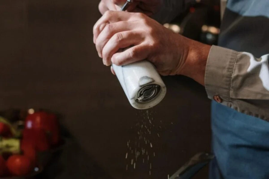 Person using a manual hand herb grinder