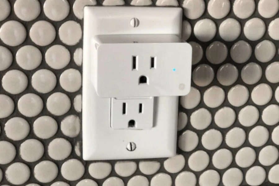White smart plug connected to power outlet
