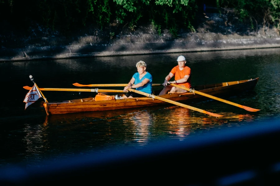 A man and a woman rowing in a boat