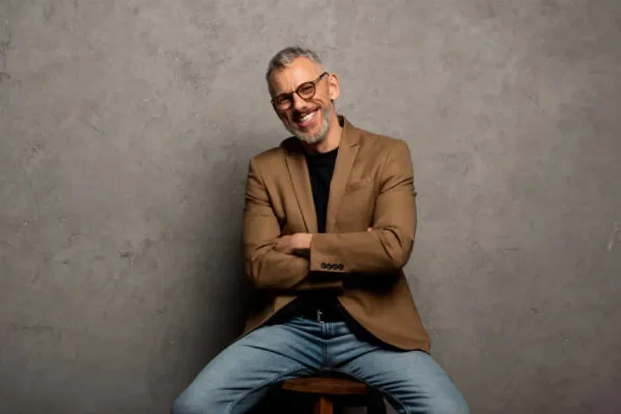 A man in glasses wearing a blazer