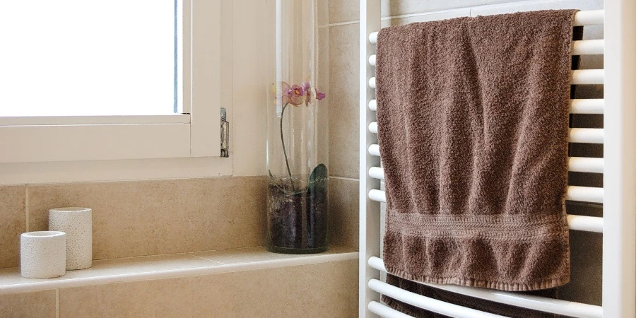 A mounted towel warmer with the brown towel