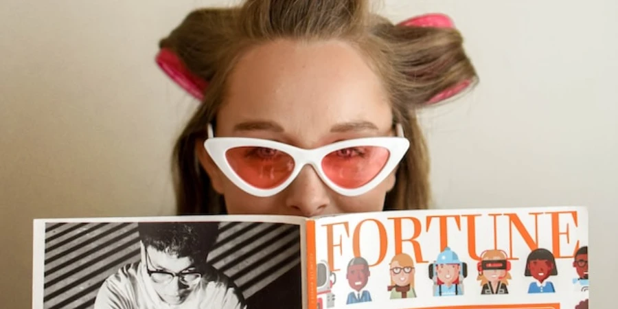 A woman wearing hair rollers reading a magazine