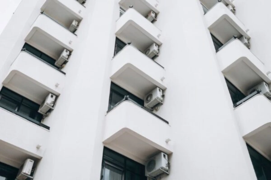an apartment building with air conditioners on every balcony