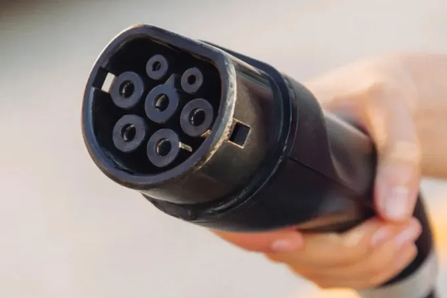 An EV plug held by hand