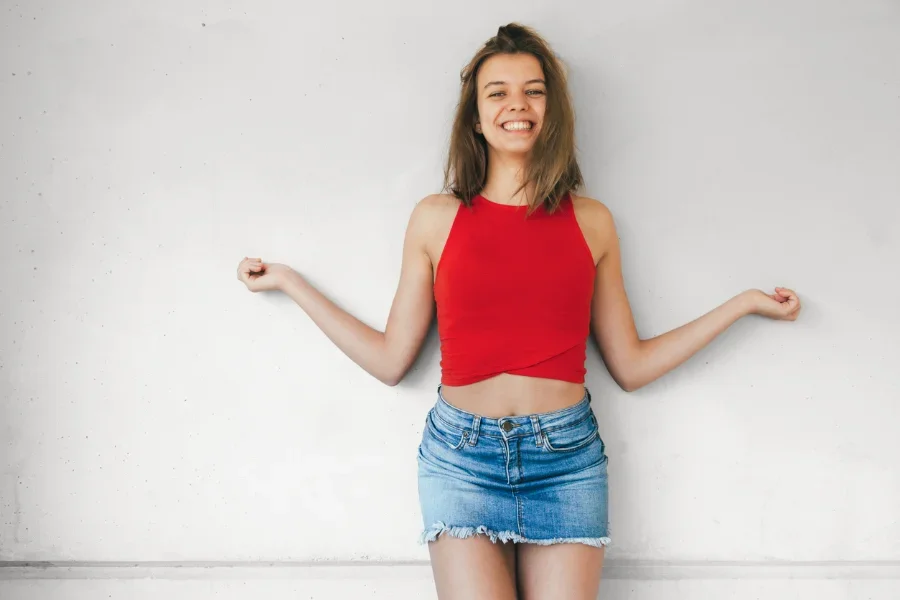 cheerful girl with denim mini skirt and red top