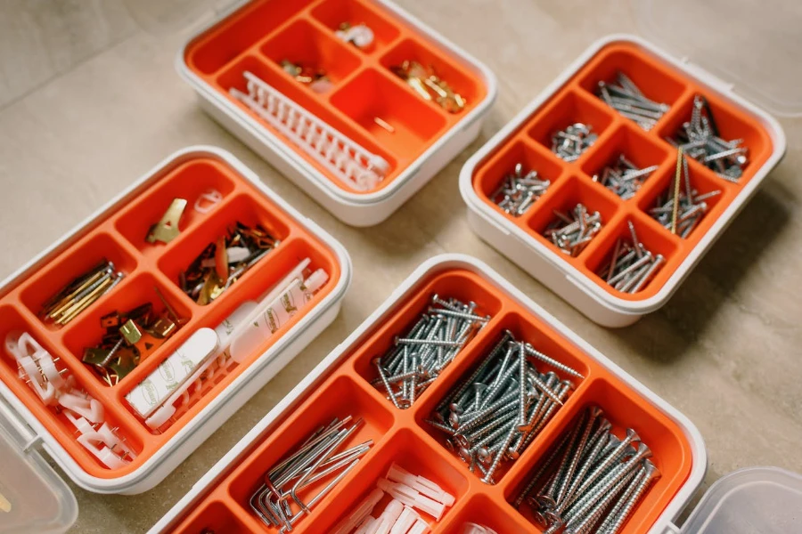 Different types and sizes of nails in partitioned containers