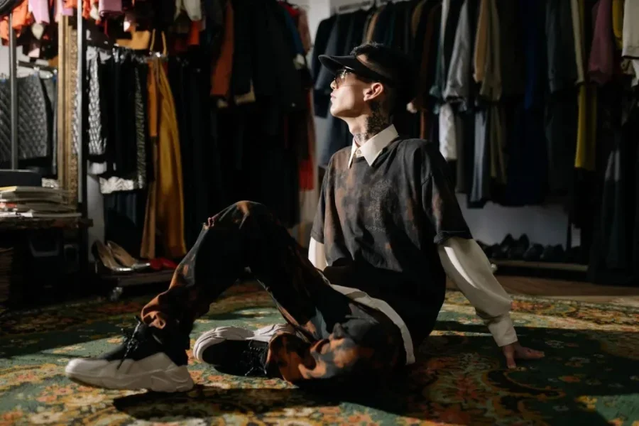 Man in vintage-inspired clothing sitting in a dressing room