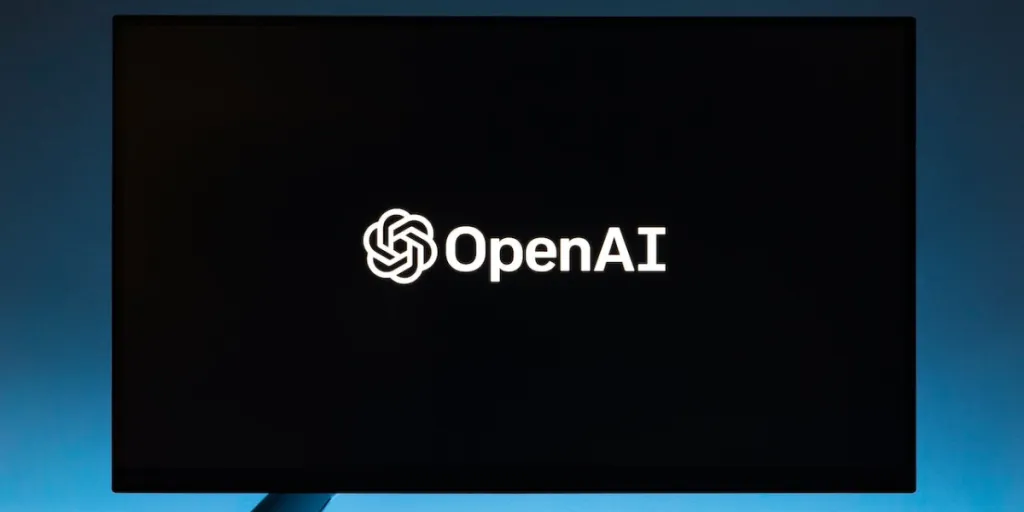 Monitor screen with OpenAI logo on black background