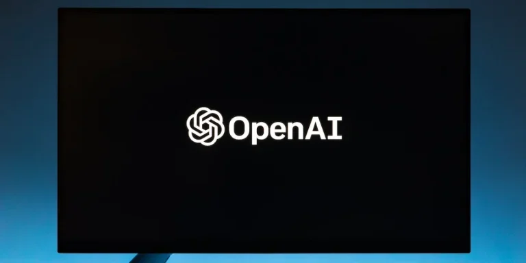 Monitor screen with OpenAI logo on black background