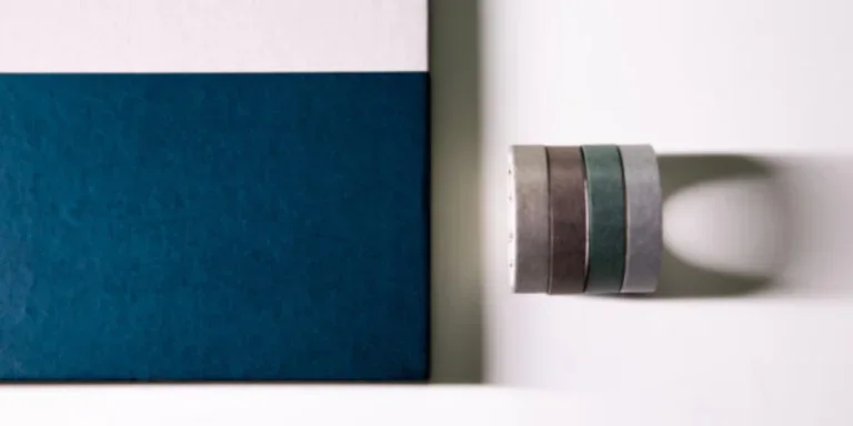 Overhead shot of washi tapes near a notebook
