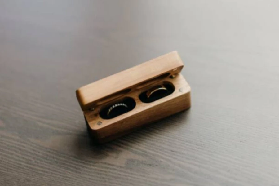 Small wooden jewelry box with two rings inside