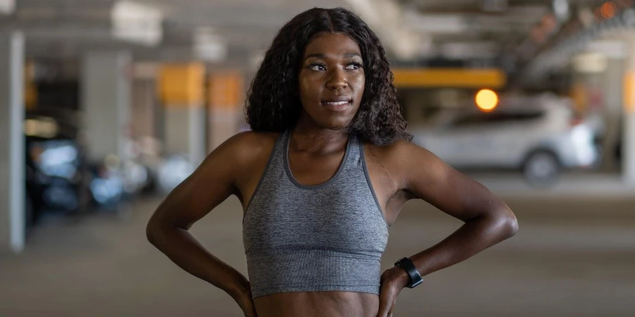 Woman in gray sports bra wearing a fitness watch