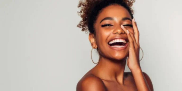 Woman wearing hoop earrings and laughing