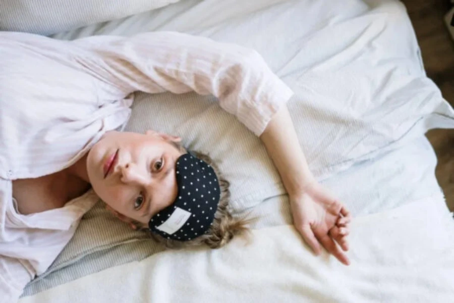 Woman wearing sustainable bamboo pajamas on bed