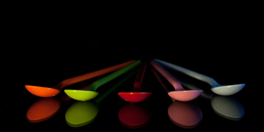 Five assorted colors of plastic spoons