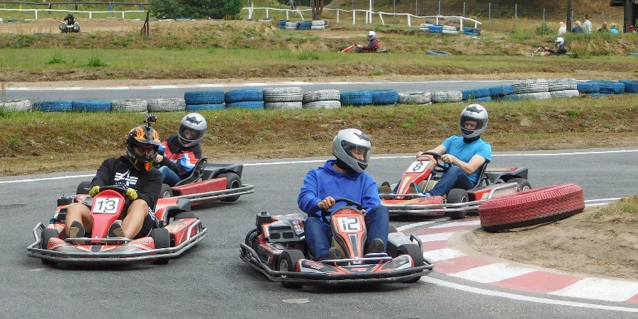 Group of go kart drivers turning a corner on a track