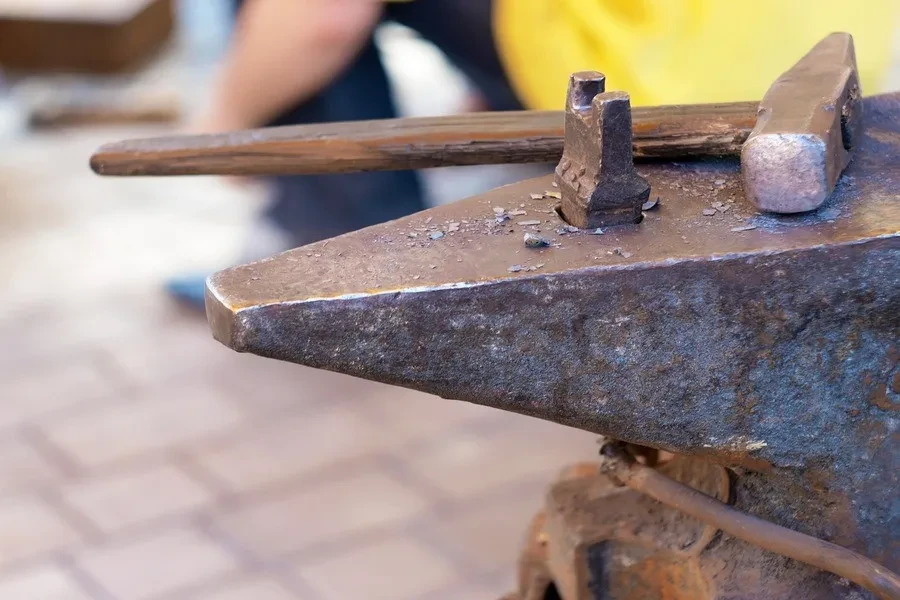 Hammer on a piece of metal in a workshop