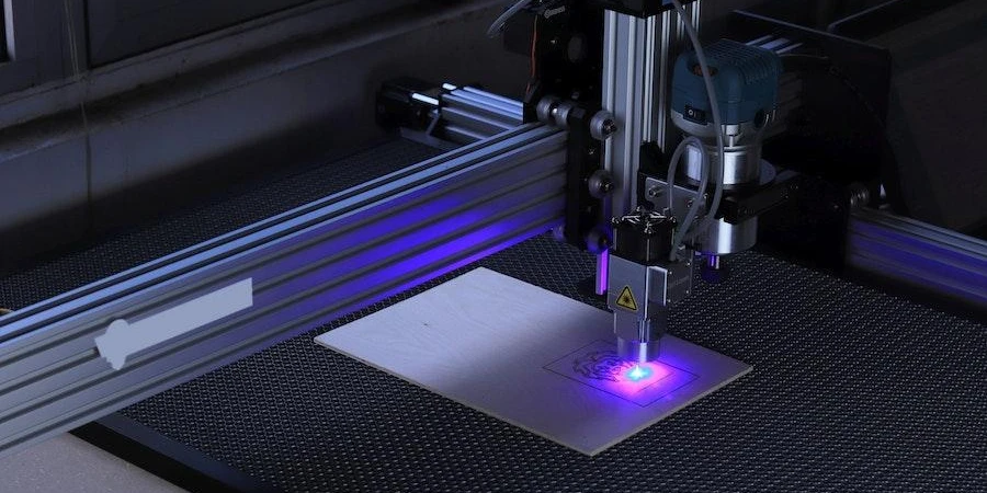 Laser machine engraving a piece of metal