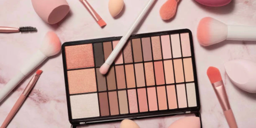 Neutral-toned eyeshadow palette and different makeup brushes