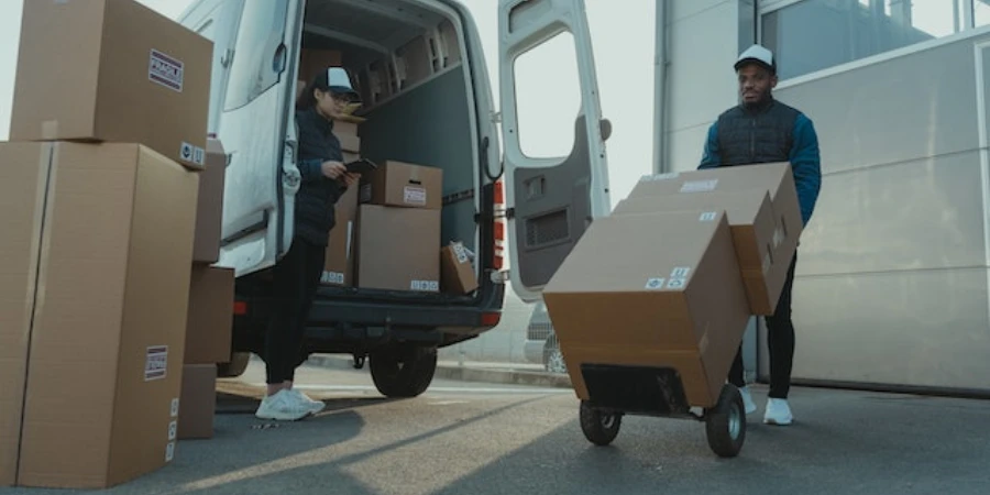 A man and a woman unloading a delivery truck