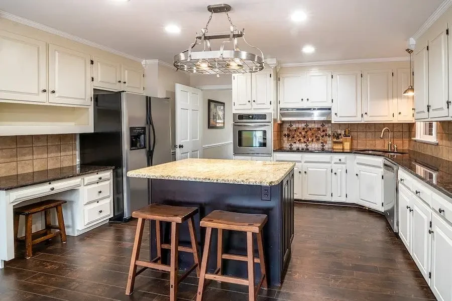 A minimalist kitchen with wood effect floor and wall tiles