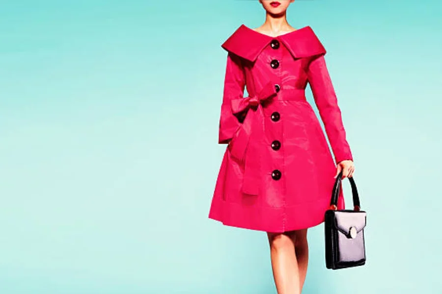 Eine Frau trägt einen leuchtend rosa Wintermantel