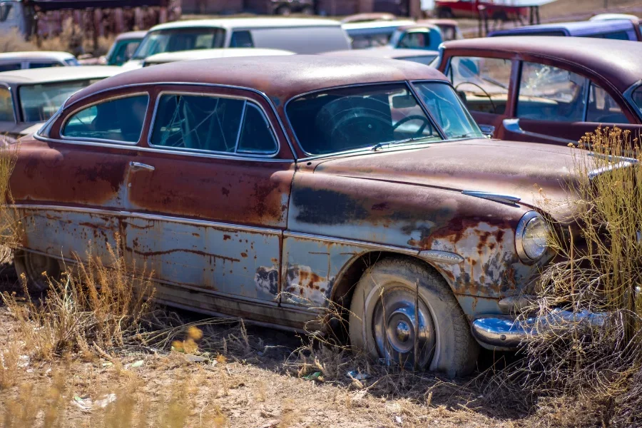 An old vehicle left to rust in a field