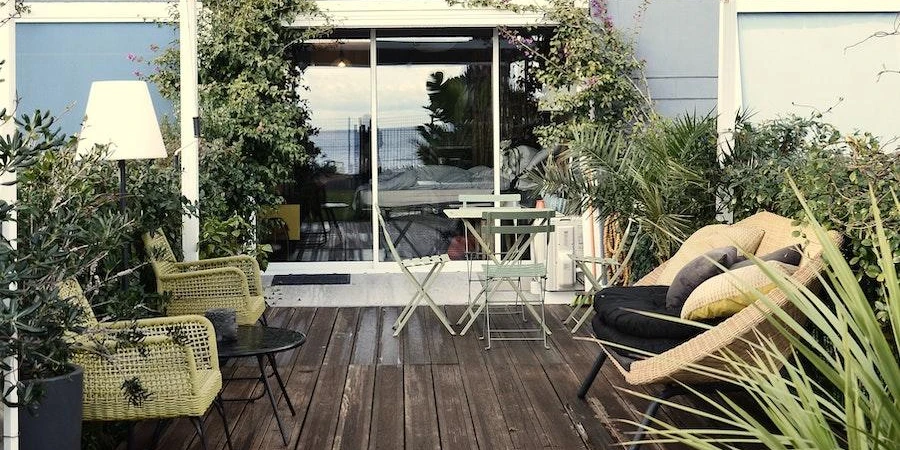 An outdoor garden with multiple rattan garden furniture