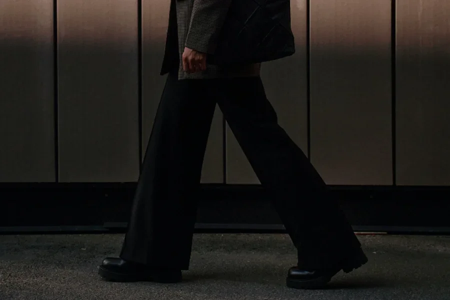 Businesswoman wearing black wide trousers