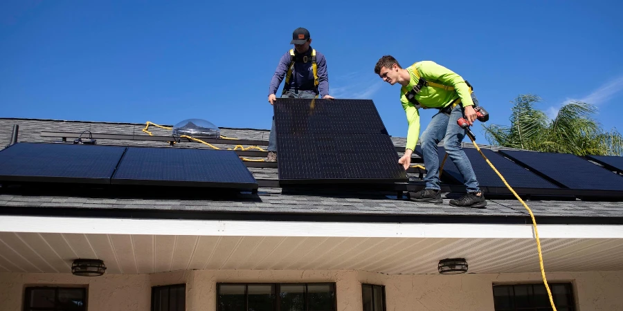 Men on top of a roof installing solar panels