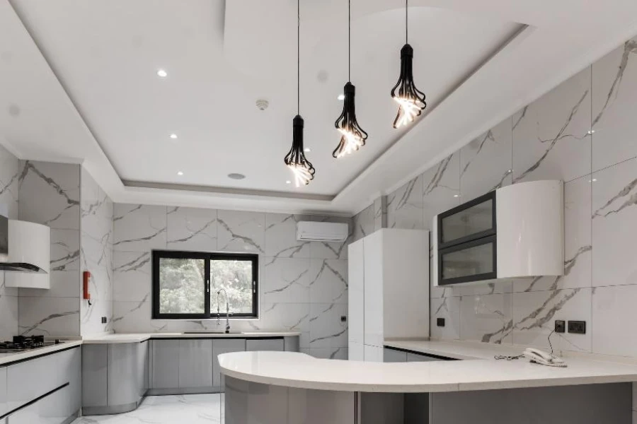 Modern home kitchen with black architectural pendant lighting