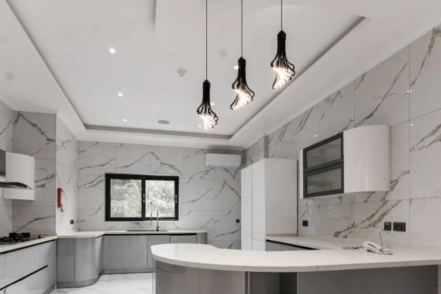 Modern home kitchen with black architectural pendant lighting