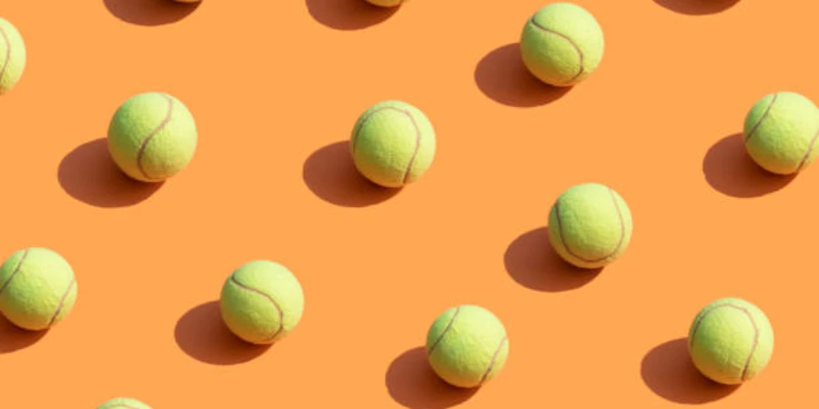 Orange background with yellow tennis balls spread out across it