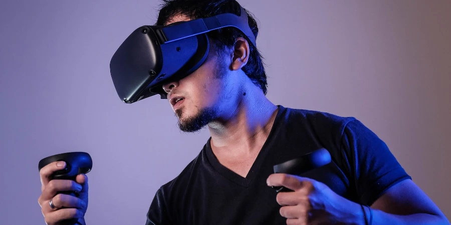 Person wearing black VR headset and holding controllers
