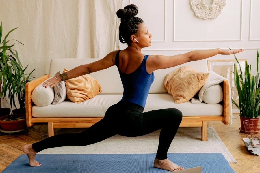 person wearing in ear headphones while doing yoga