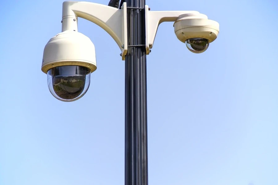 Two security cameras mounted on a pole