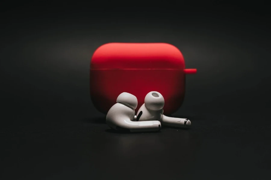 white in ear headphones beside a red case