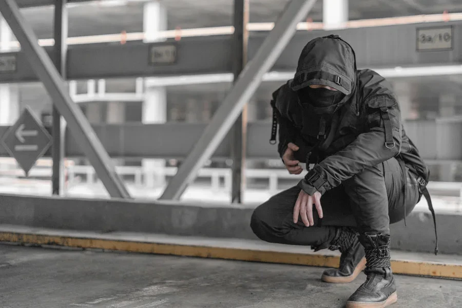 Man posing in a full techwear outfit