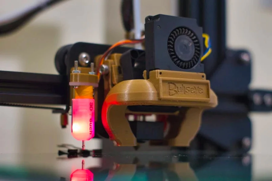 A black and gold 3D printer printing something