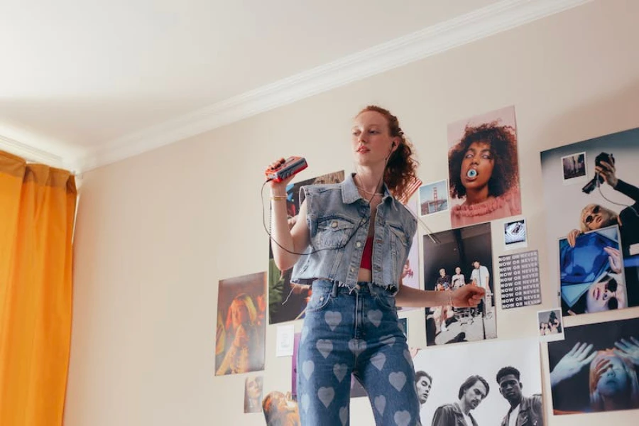 A girl in a denim outfit listening to an audio tape