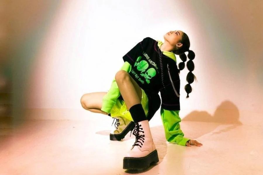 A girl wearing a vibrant green aesthetic outfit with chunky books