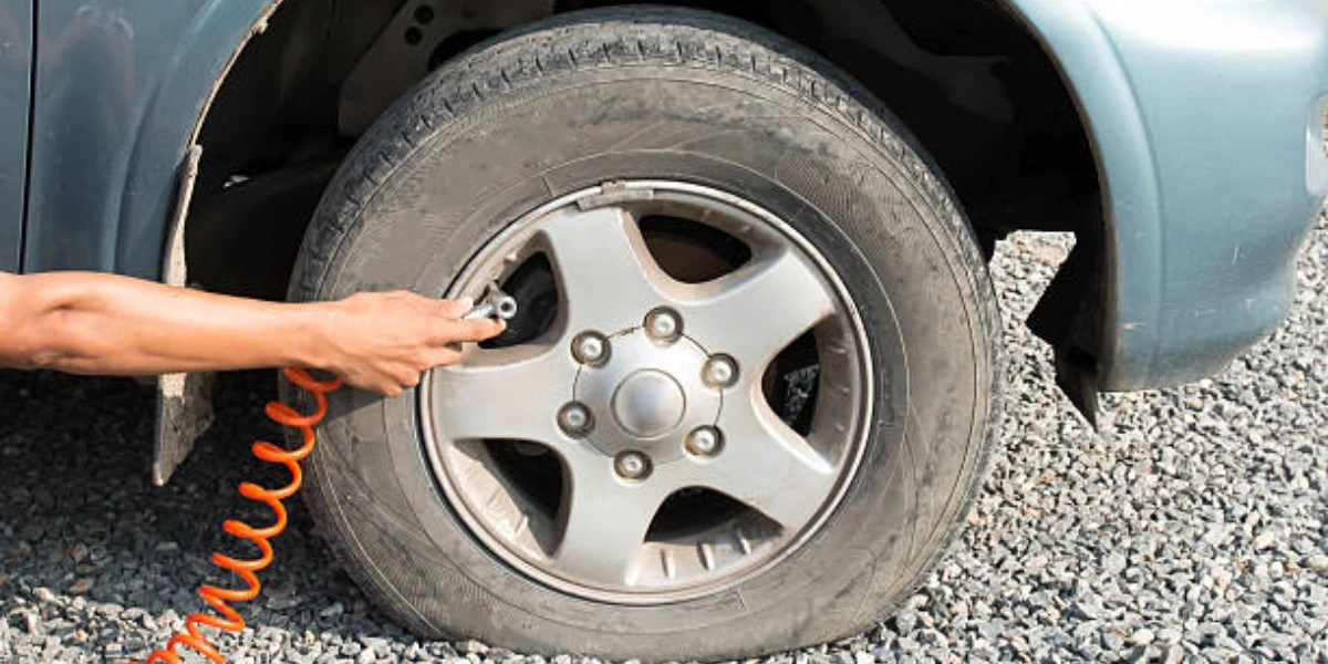 A hand filling air in a tire
