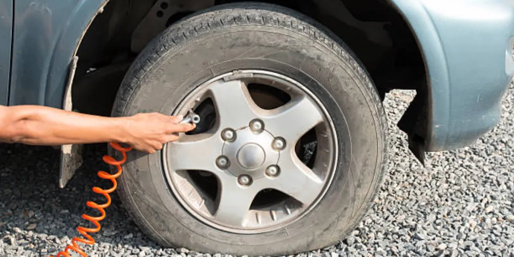 A hand filling air in a tire