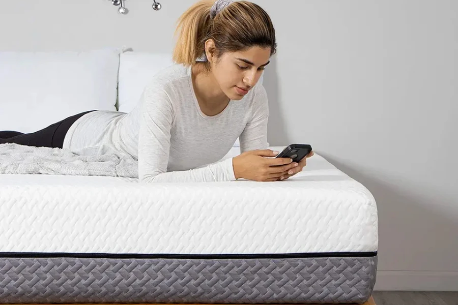 A lady lying down casually on a hybrid mattress