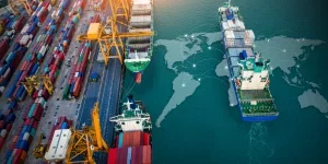 Aerial top view of container cargo ships in motion over ocean