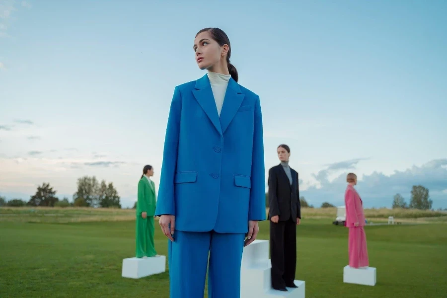 Four ladies wearing different vibrant colored suits